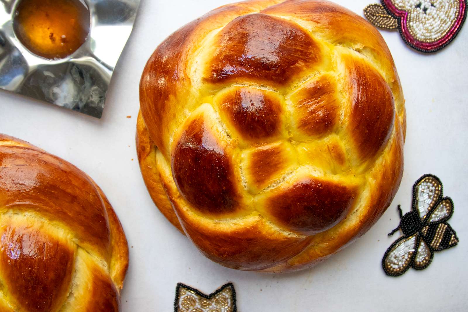 Overhead close-up of a golden woven round challah for Rosh Hashanah
