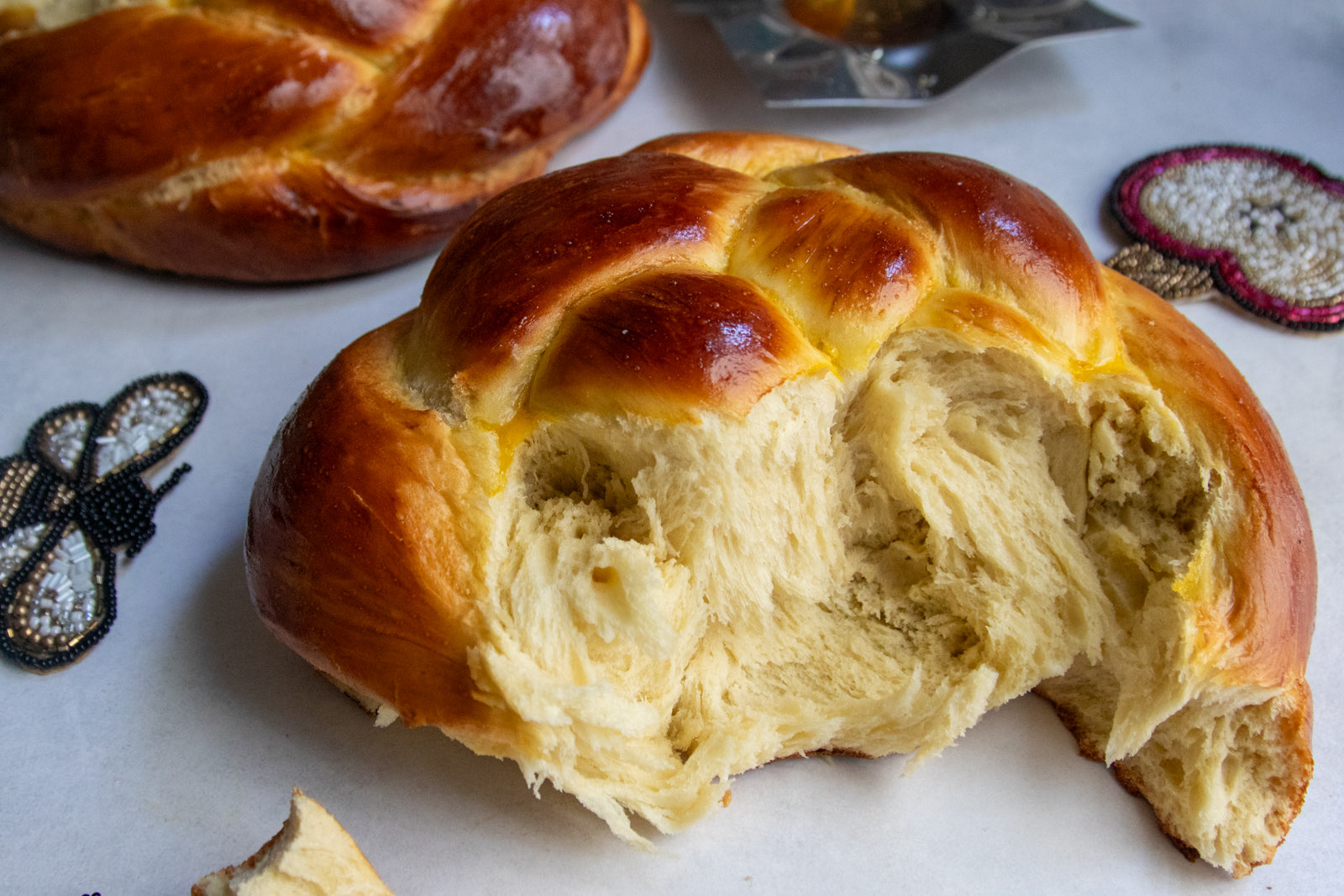 Round challah torn open to show the soft, fluffy interior